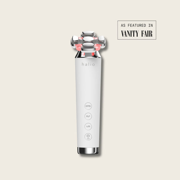 Halio RevitaWave skincare wand with four treatment heads and red lights, labeled EMS, RF, VR, and LED; As Featured in Vanity Fair