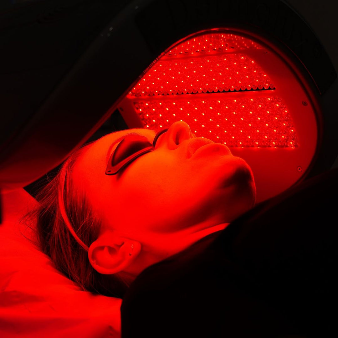 Close-up of LED red and near-infrared light shining on skin, illustrating photobiomodulation at the cellular level