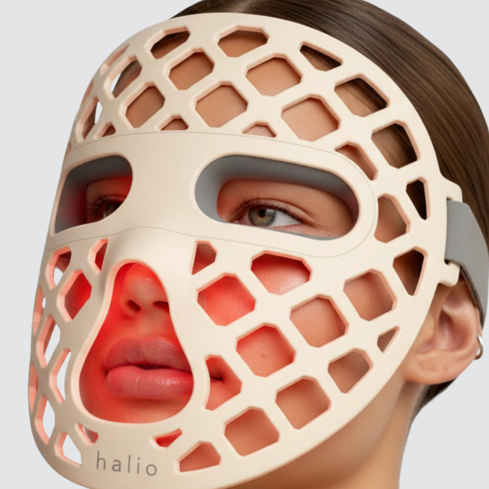 Person wearing a beige honeycomb face mask with 'halio' branding.