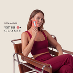 Woman using Halio red light therapy device on her face while seated in a chair; “In the spotlight VANITY FAIR GLOSSY” text visible.